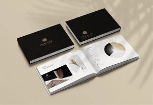 A black book on a table with a palm tree in the background.