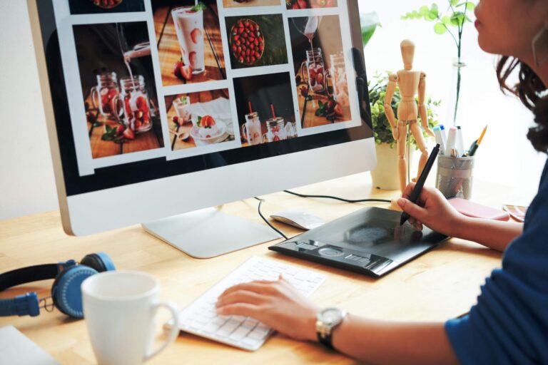 A woman is designing a mobile-first website on her computer.