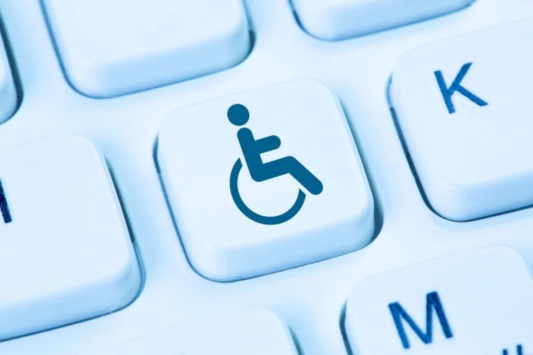 A computer keyboard featuring a wheelchair icon, following WCAG Guidelines.